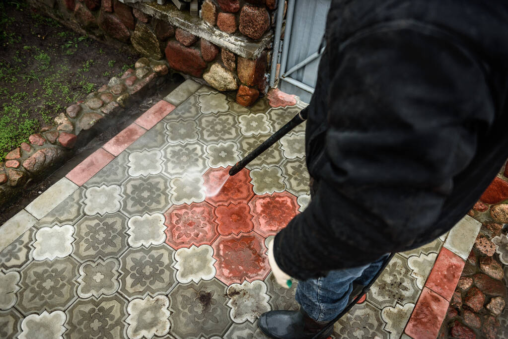 Cleaning paving slab using high pressure power washer